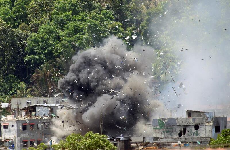 Debris and smoke seen after an OV-10 Bronco aircraft released a bomb during an air strike, as government forces continue their assault against insurgents from the Maute group, who have taken over large parts of Marawi City, Philippines on June 20, 2017. Romeo Ranoco/Reuters