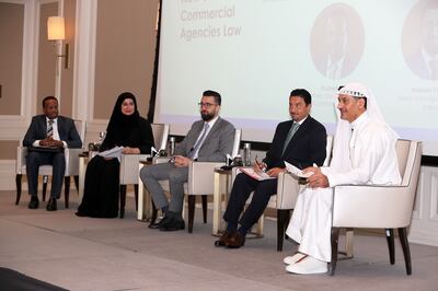 From left, El-Ameir Noor, partner at Al Tamimi & Company; Ayesha Al Mulla, FNC member; Kassem Younes, senior managing director of Ankura; Hasan Al Kilany, senior legal counsel in the Ministry of Economy; and Essam Al Tamimi, chairman of Al Tamimi & Company, attend a panel discussion on the new commercial agencies law on Monday. Pawan Singh / The National 