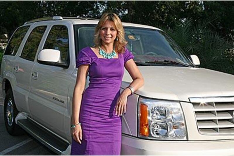 Lea-Ann Randall, a business development manager in Dubai, pictured with her 2005 pearl white Cadillac Escalade. Ms Randall bought the SUV 18 months ago from a friend.