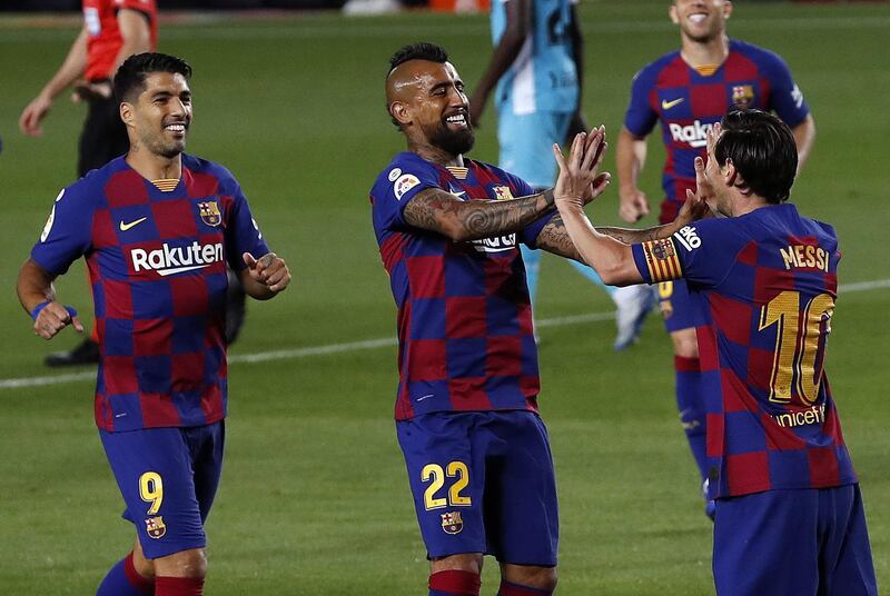 Lionel Messi celebrates with Arturo Vidal and Luis Suarez after scoring the second goal against Leganes at Camp Nou. EPA