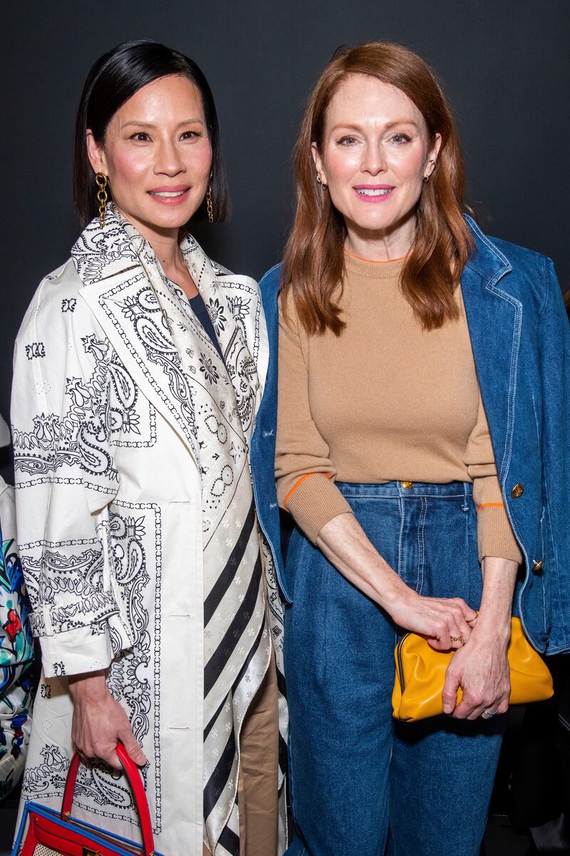 Lucy Liu, left, and Julianne Moore attend the Tory Burch fashion show at Sotheby's during NYFW Fall/Winter 2020 on Sunday, Feb. 9, 2020, in New York. (Photo by Charles Sykes/Invision/AP)