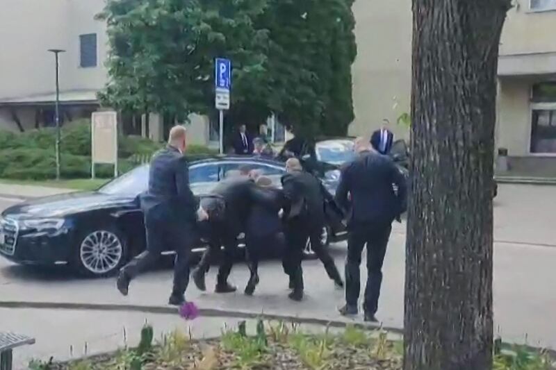 Security officers carry Mr Fico in a picture taken from video. AFP