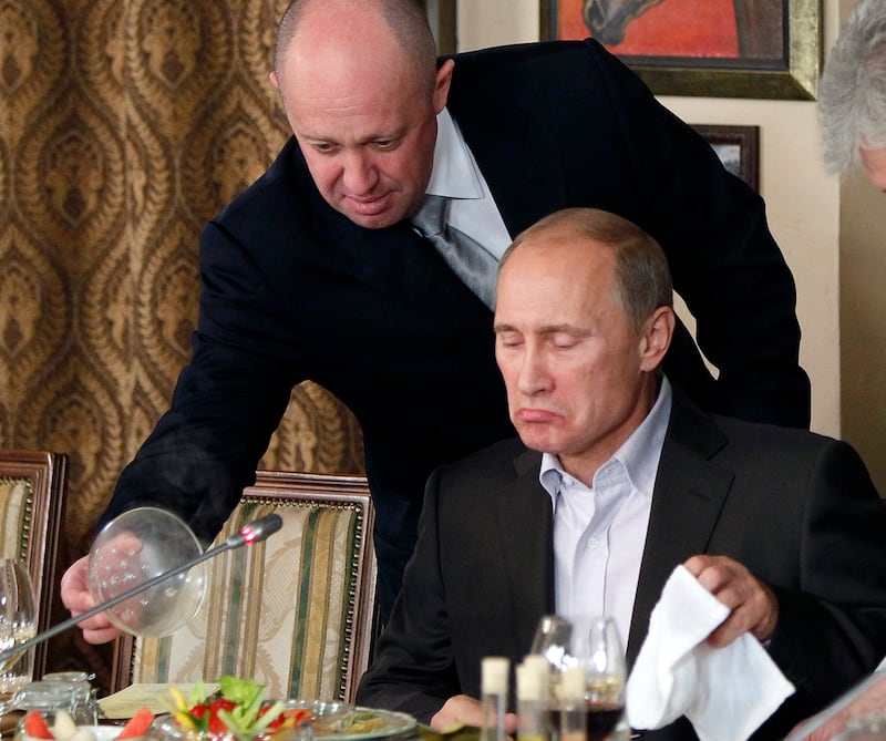 Mr Prigozhin serves food to Mr Putin, who at the time was Russia's prime minister, at the Wagner chief's restaurant outside Moscow. AP 