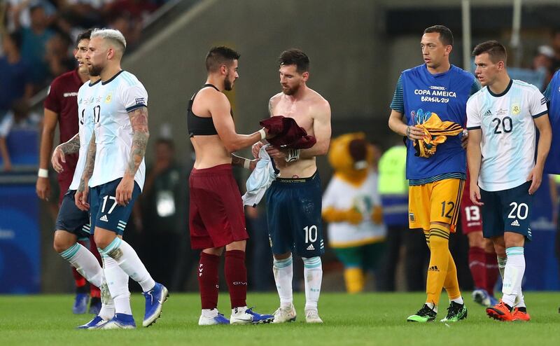 Venezuela's Junior Moreno and Argentina's Lionel Messi swap shirts after the match. Reuters