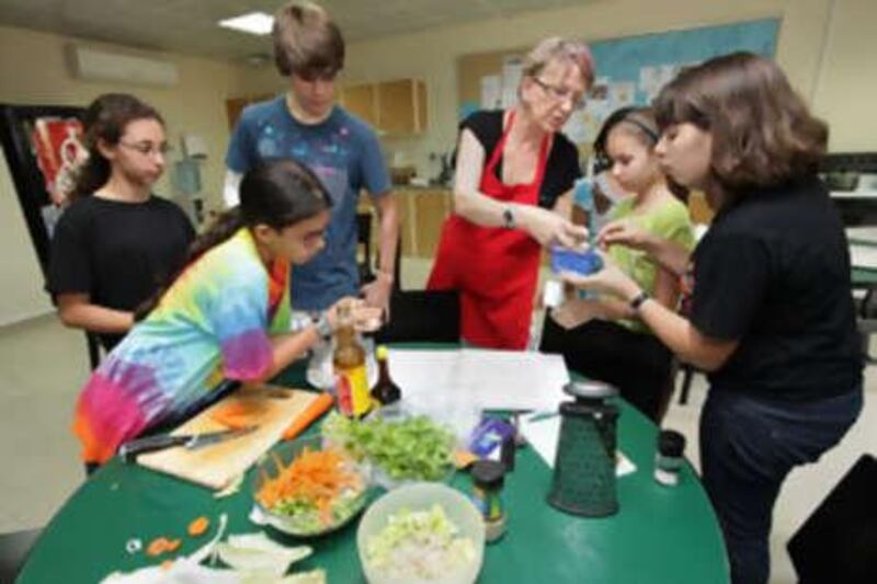 Children learn how to cook with Stefanie Goeble at the American Community School in Abu Dhabi.