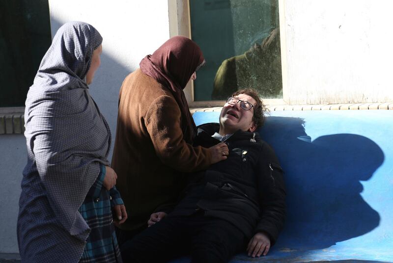 Two women console a man outside a hospital following a suicide attack in Kabul, Afghanistan. Rahmat Gul / AP Photo