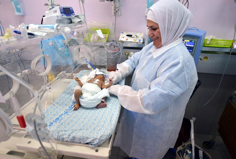 A medic takes care of a baby in a neo-natal unit at the hospital. Photo: Getty images