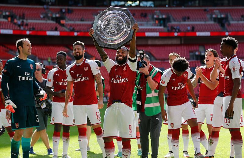 Arsenal players celebrate with the trophy after winning the English Community Shield soccer match between Arsenal and Chelsea at Wembley Stadium in London, Sunday, Aug. 6, 2017. (AP Photo/Frank Augstein)