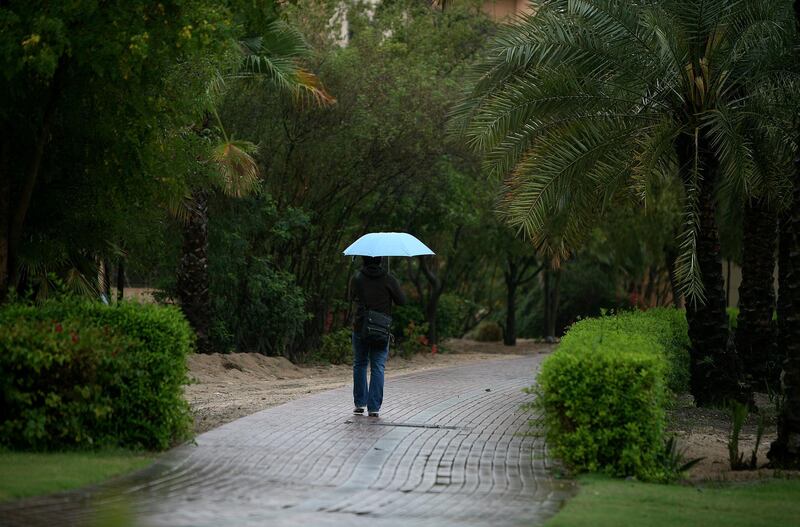 
DUBAI, UNITED ARAB EMIRATES, Mar 2- One of the resident walking in the rain near The Gardens in Dubai. (Pawan Singh / The National) For News
