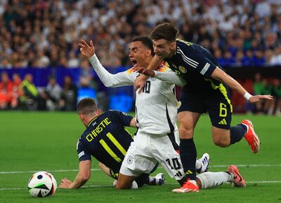 Goal scorer Jamal Musiala, centre, of Germany is fouled during his team's Euros match against Scotland. EPA