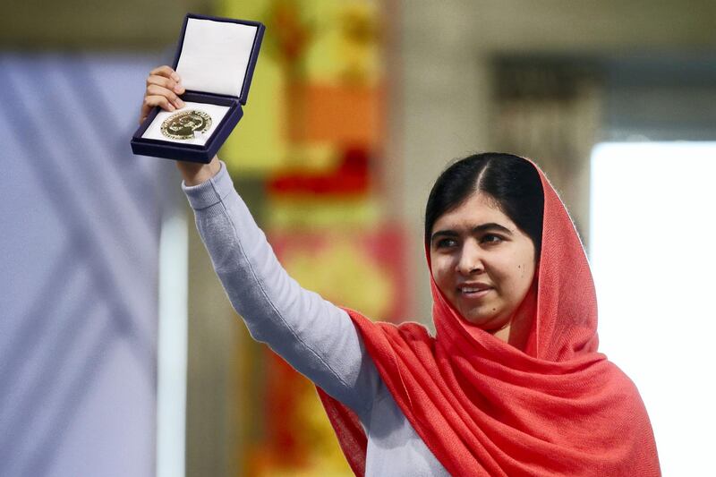 Nobel Peace Prize laureate Malala Yousafzai displays her medal during the Nobel Peace Prize awards ceremony at the City Hall in Oslo, Norway, on December 10, 2014. 17-year-old Pakistani girls' education activist Malala Yousafzai known as Malala shares the 2014 peace prize with the Indian campaigner Kailash Satyarthi, 60, who has fought for 35 years to free thousands of children from virtual slave labour.      AFP PHOTO /POOL/CORNELIUS POPPE / AFP PHOTO / POOL / CORNELIUS POPPE