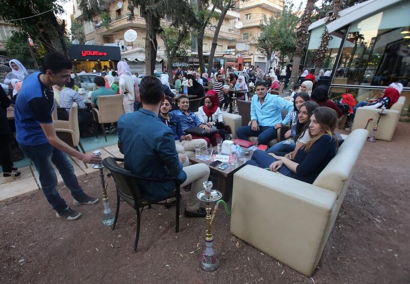 Syrian youths at a cafe in the government-held area of the northern Syrian city of Aleppo as they celebrate the Eid al-Adha Muslim holiday on September 13, 2016, a day after a fragile ceasefire was brokered. Youssef Karwashan / AFP 



 