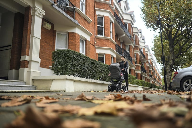 LONDON, ENGLAND - OCTOBER 26: A woman walks with a pushchair past a row of apartments in Maida Vale on October 26, 2020 in London, England. As many young people renting rooms have left the capital due to the Coronavirus Pandemic, rents are dropping and in some places have fallen by a third. Aldgate has seen a 34% fall in price per room, whilst prices in Little Venice and Maida Vale dropped by 20%. The average rent drop for a room in London's Zone one dropped by 11% in comparison to this time last year. (Photo by Peter Summers/Getty Images)