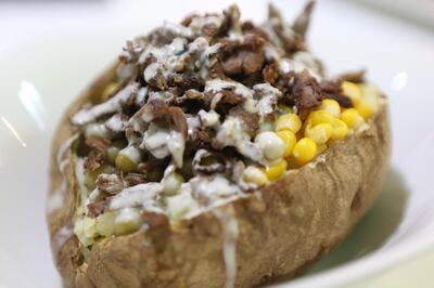 ABU DHABI, UNITED ARAB EMIRATES - - -  May 12, 2014 --- The baked potato with buffalo shaved on top at Shawarma Time restaurant on Najda Street in Abu Dhabi on Monday, May 12, 2014.    ( DELORES JOHNSON / The National )  ******** Reporter Jessica Hill  *******