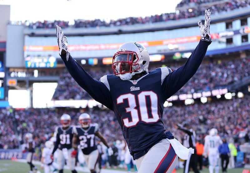 New England Patriots defensive back Duron Harmon celebrates after an interception returned for a touchdown on Sunday in his team's NFL win against the Dolphins. Matt Campbell / EPA / December 14, 2014  