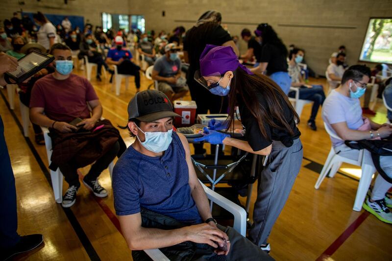 Humber River Hospital doctor Agarwal Seema administers a COVID-19 vaccine at a clinic planned for and organized by the Latino community, an ethno-racial group more at risk of hospitalization from coronavirus disease (COVID-19) according to city of Toronto data, in Toronto, Canada May 14, 2021. Picture taken May 14, 2021.REUTERS/Carlos Osorio