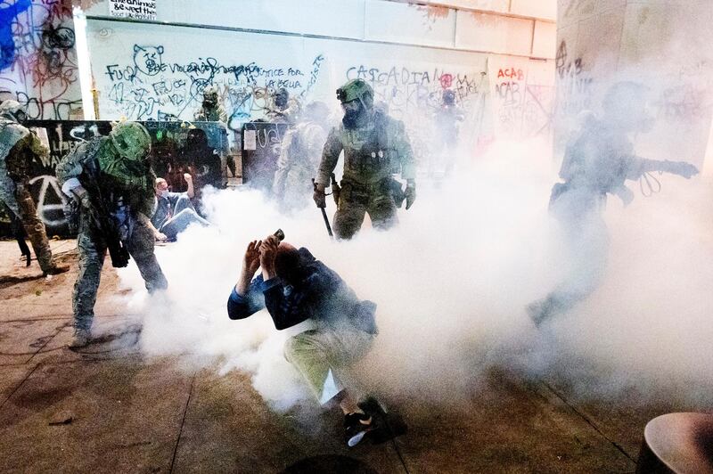 Federal officers use chemical irritants and crowd control munitions to disperse Black Lives Matter protesters outside the Mark O Hatfield United States Courthouse in Portland, Oregon, US. AP Photo