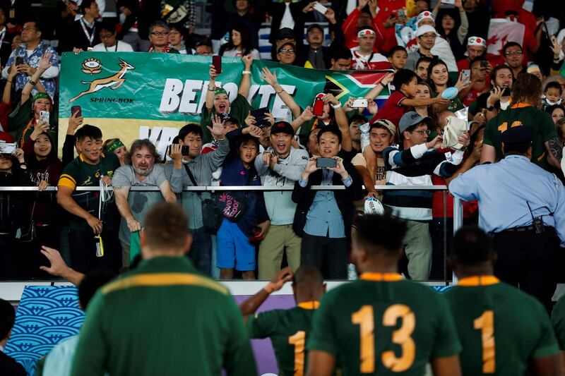 Fans wave at South Africa's players after they won the Japan 2019 Rugby World Cup semi-final match between Wales and South Africa at the International Stadium Yokohama in Yokohama.  AFP