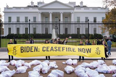 A large banner along with fake white body bags, representing those killed in the escalating conflict in Gaza and Israel, is displayed in front of the White House in November. AP
