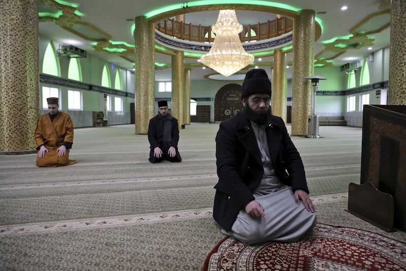 The staff of a Palestinian mosque pray at an empty building as all the mosques in the Hebron area are closed amids the coronavirus pandemic.  AFP