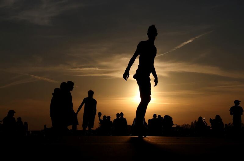 People enjoy the sunset at the Tempelhofer Feld, in Berlin, Germany. Reuters