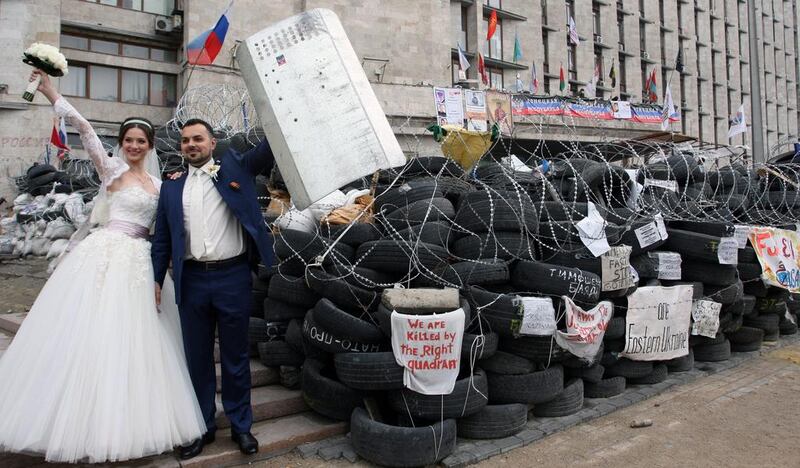 A couple on their wedding day poses at the barricades in the center of Donetsk in downtown of Donetsk, Ukraine. Igor Kovalenko / EPA / May 2, 2014