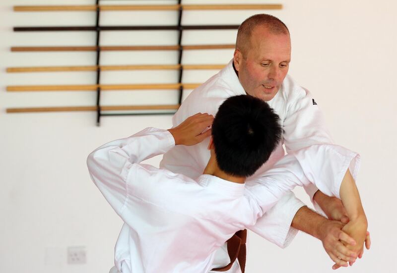 Dubai, United Arab Emirates - July 20, 2019: Chua Ken Yu (L) with Burim Berisha. Cathy Darnell is the only female Aikido instructor in Dubai and is a 4th dan, she has the oldest dojo in the country, Zanshinkan Aikido club Dubai is celebrating our 25th anniversary in 2020. Saturday the 20th of July 2019. Al Barsha, Dubai. Chris Whiteoak / The National