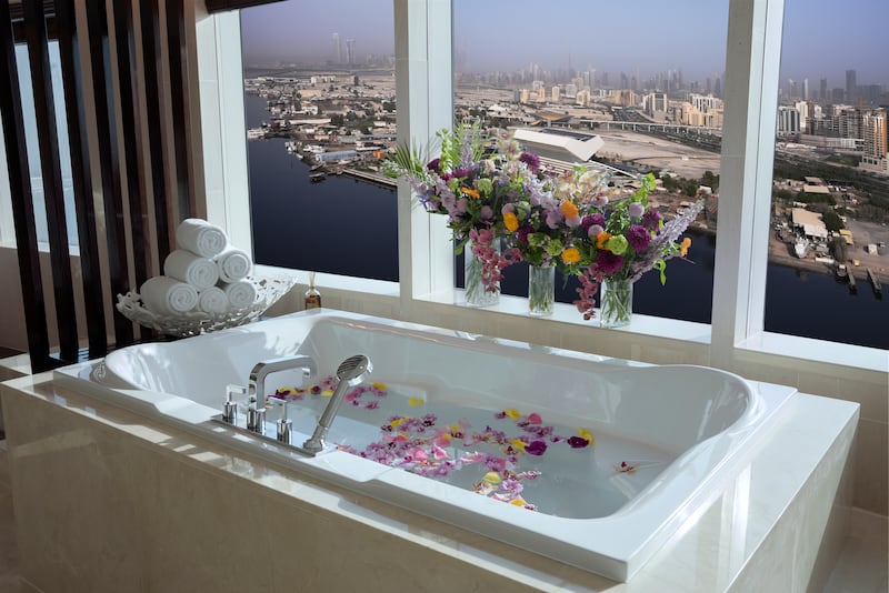 Draw a bath, complete with flower petals, and soak in the views across Dubai Creek. The windows are sunset-facing, too.