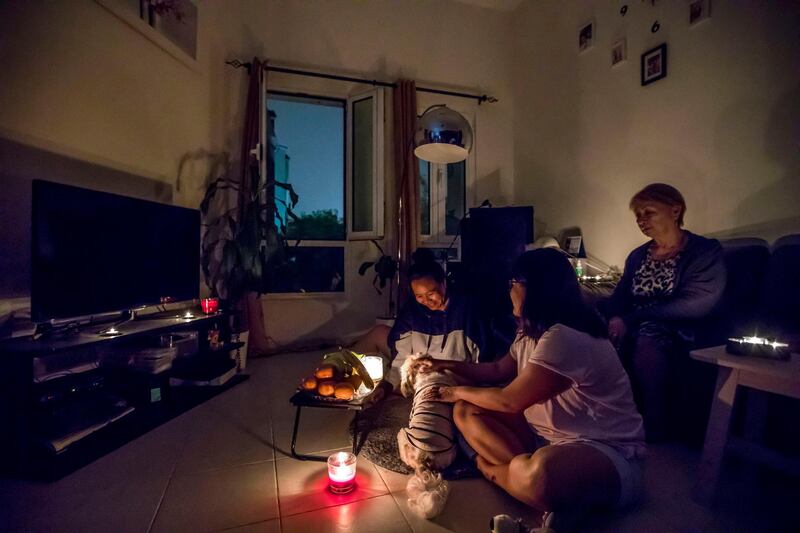Dubai, United Arab Emirates- A family playing with their pet during Earth Hour.  Ruel Pableo for The National
