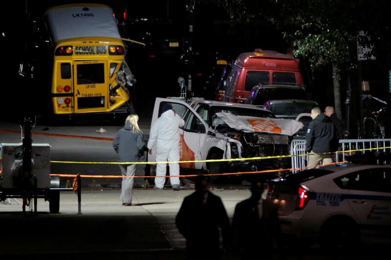 Police investigate a pickup truck used in an attack on the West Side Highway in Manhattan, New York, U.S., November 1, 2017.  REUTERS/Andrew Kelly     TPX IMAGES OF THE DAY