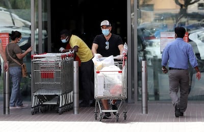 DUBAI, UNITED ARAB EMIRATES , April 05 – 2020 :- One of the shopper with protective face mask after doing shopping at the Carrefour supermarket in Ibn Battuta mall in Dubai. UAE government told residents to wear facemask and gloves all the times outside the home. (Pawan Singh / The National) For News/Online/Instagram.