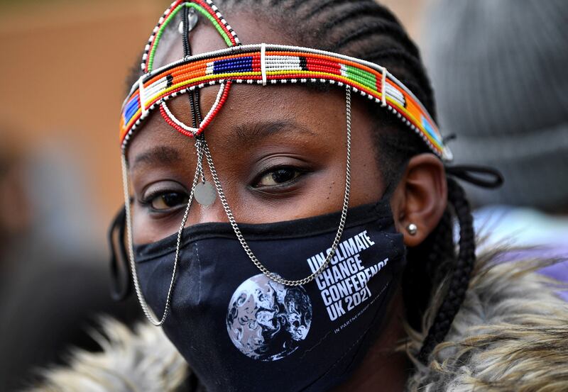 A demonstrator wearing a Cop26-themed mask attends the Fridays for Future march. Reuters