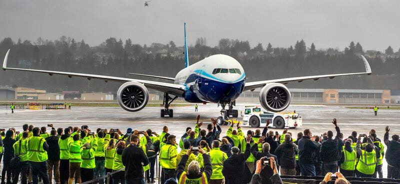 Boeing employees and other guests cheer the 777X after its landing.  AP