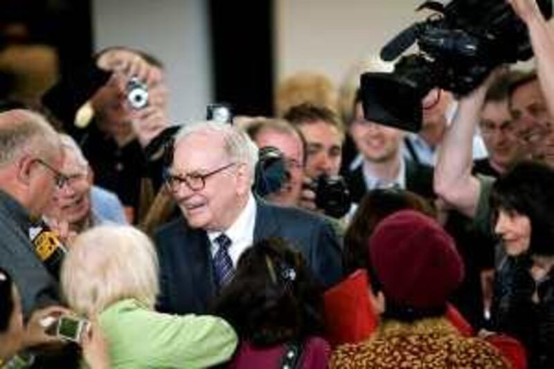 Warren Buffett, chairman of Berkshire Hathaway Inc., greets attendees as part of the Berkshire Hathaway annual shareholder meeting weekend in Omaha, Nebraska, U.S., on Sunday, May 3, 2009. Buffett said all four candidates to replace him as chief investment officer of Berkshire Hathaway failed to beat the 38 percent decline of the Standard & Poorís 500 Index last year. Photographer: Andrew Harrer/Bloomberg News