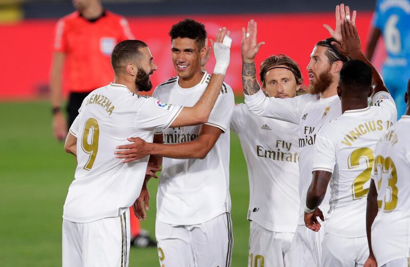 Real Madrid's Karim Benzema, left, celebrates with his teammates after scoring his side's third goal against Valencia on Thursday. AP