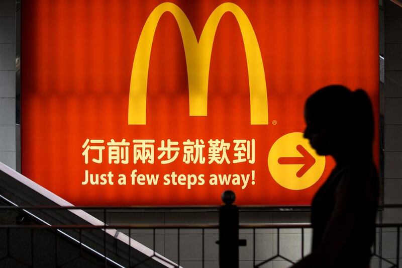 A woman walks past a logo of McDonald’s in Hong. McDonald’s has suspended sales of chicken nuggets and other items in Hong Kong after it said it had imported products from Shanghai Husi Food, the US-owned company at the centre of a food safety scare in China. Tyrone Siu / Reuters