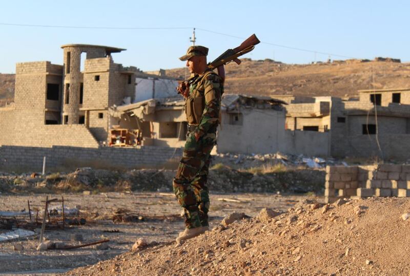 A peshmerga fighter takes in the destruction in Sinjar. ISIL holds towns nearby and must be fought, leaders say. Florian Neuhof for The National 