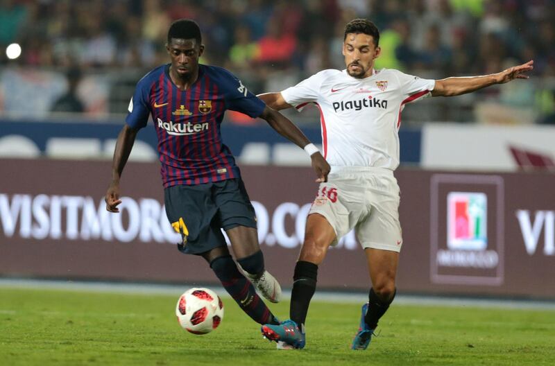 Barcelona's Ousmane Dembele vies for the ball with Sevilla's Jesus Navas. AP Photo