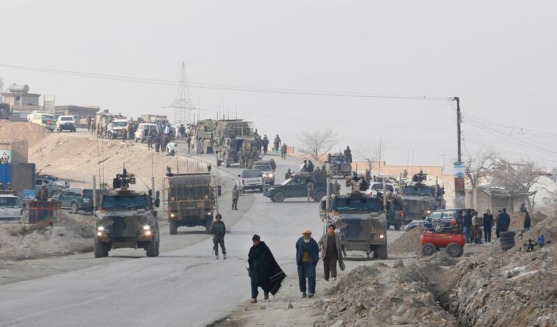 epa07223001 Afghan security officials inspect the scene of a suicide bomb attack, which targeted a convoy of security forces, in Paghman, on the outskirts of Kabul, Afghanistan, 11 December 2018. At least two British soldiers and four Afghan Special Forces soldiers were killed and dozens were injured. As the convoy was traveling to the Kandahar highway a car bomb hit their convoy.  EPA/JAWAD JALALI