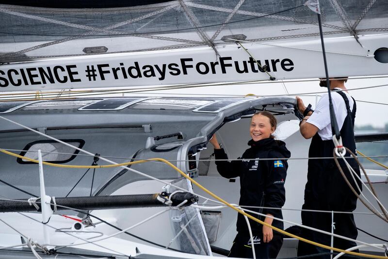 Greta Thunberg, A 16-year-old Swedish climate activist smiles as she sails into New York harbor aboard the Malizia II, Wednesday, Aug. 28, 2019. The zero-emissions yacht left Plymouth, England on Aug. 14. She is scheduled to address the United Nations Climate Action Summit on Sept. 23.  (AP Photo/Craig Ruttle)