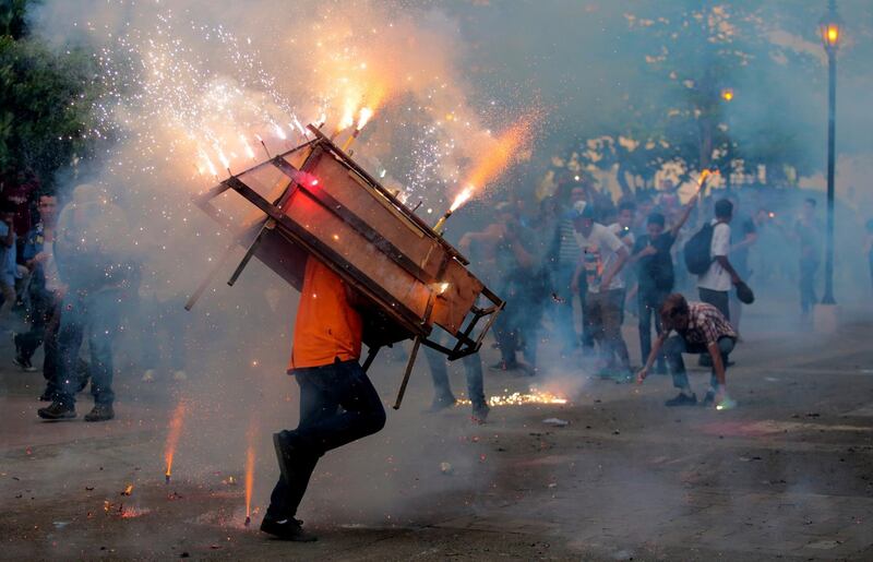 A man runs with a 'toro encuetado', a structure resembling a bull and emitting exploding firecrackers, during celebration in honour of the Virgin Mary in Leon, Nicaragua. Oswaldo Rivas / Reuters