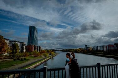 A woman walks over a bridge with the European Central Bank in the background in Frankfurt, Germany. Non-German lenders are in the process of moving an additional €397 billion to Germany. AP