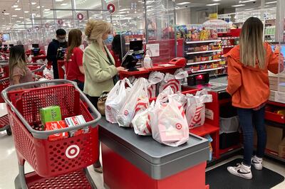 A customer waits to get a receipt at a register in Target store in Vernon Hills. US consumers are facing higher prices for food, gasoline and other basic items. AP