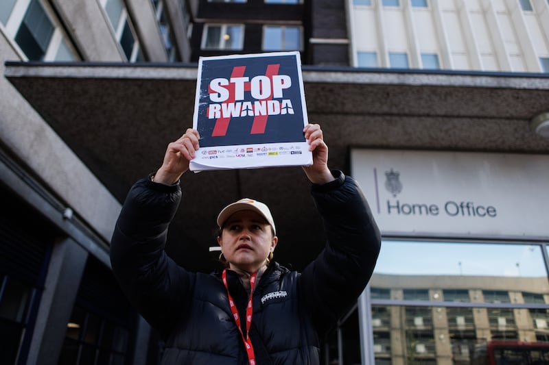 Campaigners protest against the British government's Rwanda deportation scheme outside an immigration reporting centre in Croydon, south London. EPA