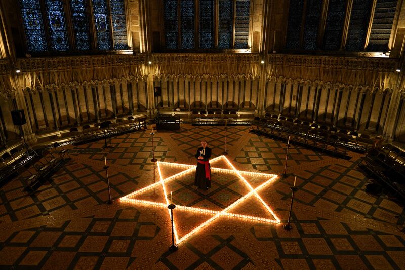 The Reverend Canon Michael Smith, Acting Dean of York, lights some of the 600 candles in the shape of the Star of David on the floor of the Chapter House of York Minster, as part of a commemoration for Holocaust Memorial Day in York, England.  Getty Images