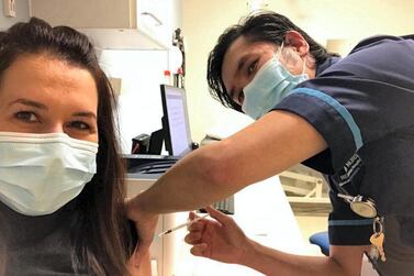 Mariana Agiu, a critical care nurse during the first waves, receives her first Covid-19 vaccine. Courtesy Mariana Agiu