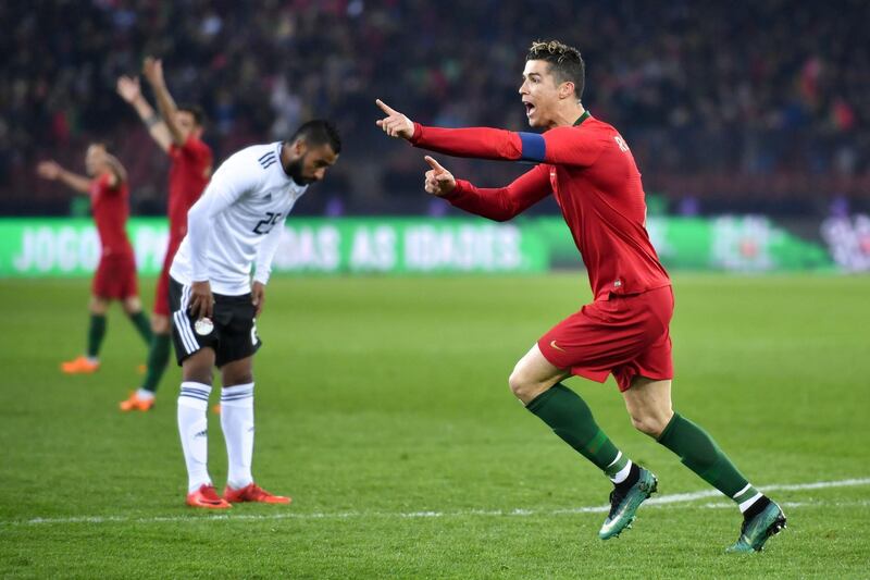 Portugal's forward Cristiano Ronaldo (R) reacts after scoring a goal during the international friendly football match between Portugal and Egypt at Letzigrund stadium in Zurich on March 23, 2018. / AFP PHOTO / Fabrice COFFRINI
