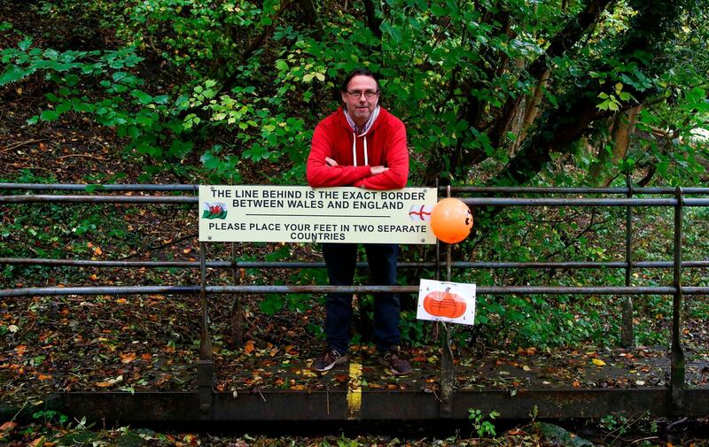 Mayor of Knighton Nick Johns, poses on the border between England and Wales. AFP