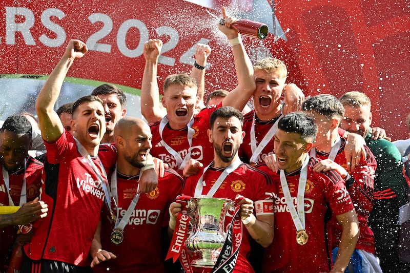 Manchester United's players celebrate with the FA Cup after beating Manchester City 2-1 in the final at Wembley. AFP