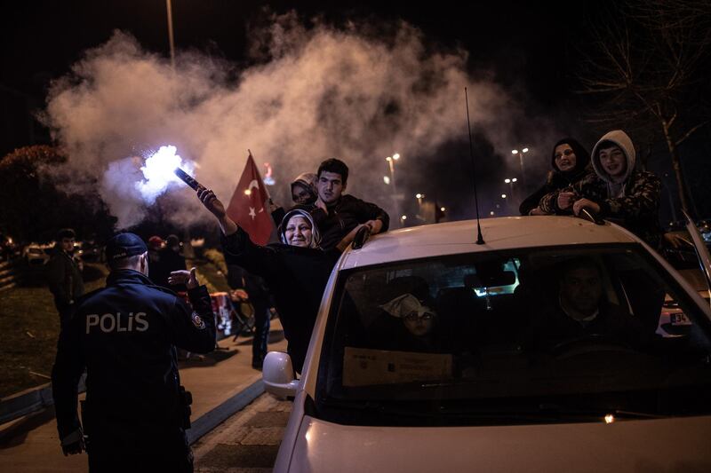 Supporters of Justice and Development Party (AK Party) hold Turkish flags as they celebrate early results for Istanbul mayor in local elections in Istanbul. EPA